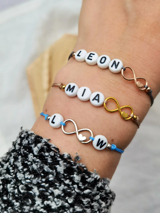 Tragefoto drei Namensarmbänder mit Unendlichkeitszeichen in roségold, gold und silber