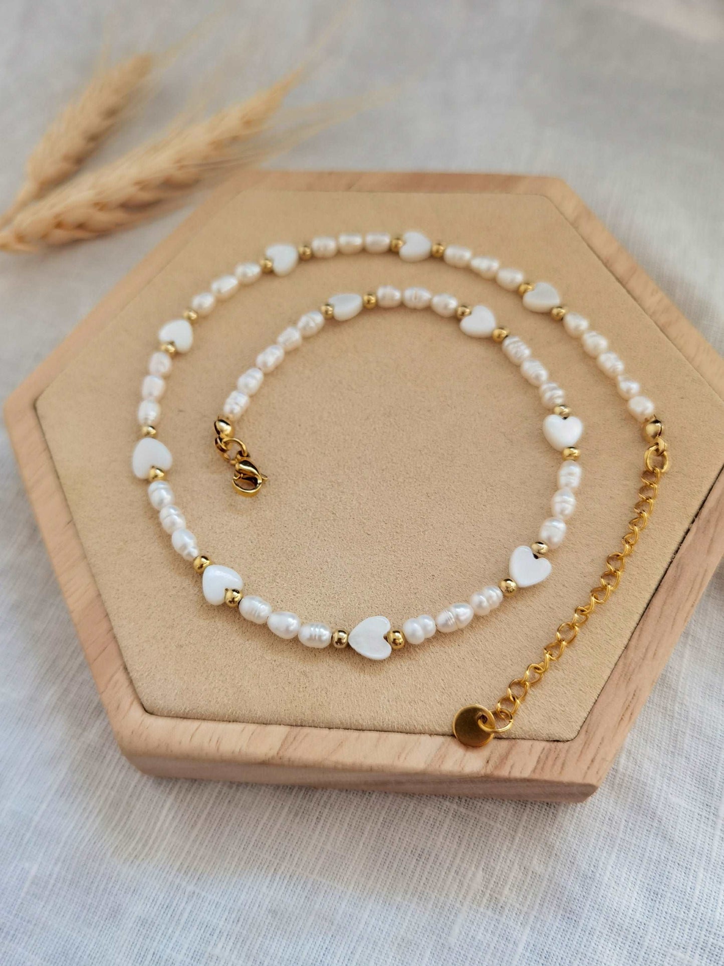 Nahaufnahme Süßwasserperlen Kette mit kleinen Herzen und goldenen Perlen