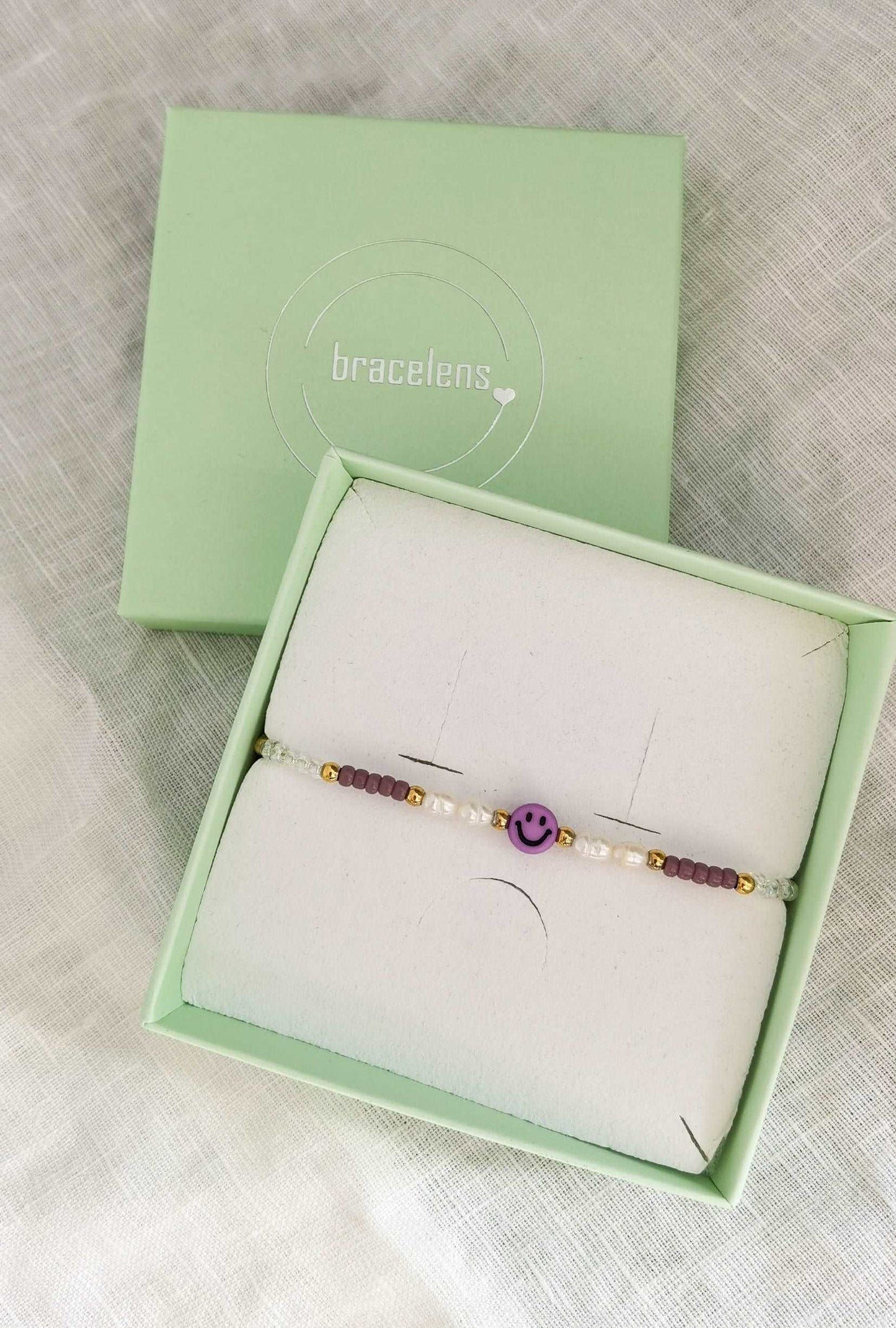 Lila Smiley Armband mit Süßwasserperlen in mintgrüner Schmuckschachtel