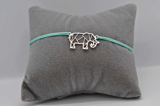 Armband Elefant silber mit mintgrünem Band auf einem grauen Schmuckkissen